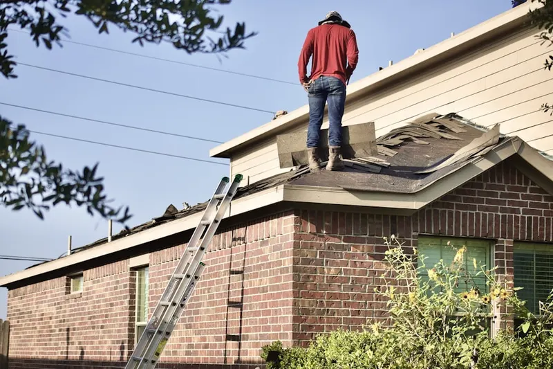 Professional roofer working on a residential roof in Bryte